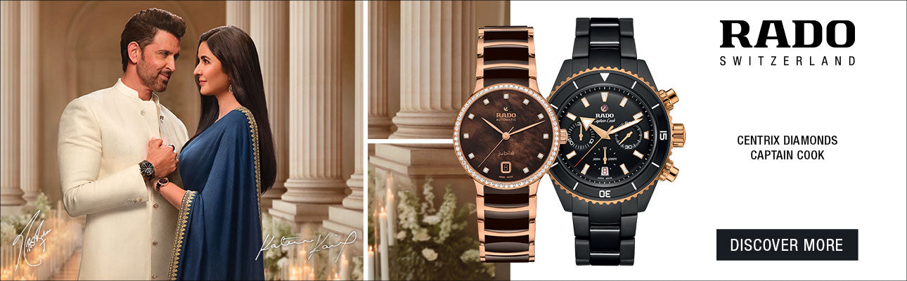 Two watches displayed with a couple in the background, Rado brand visible