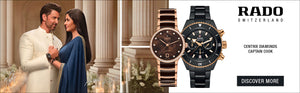 Two watches displayed with a couple in the background, Rado brand visible