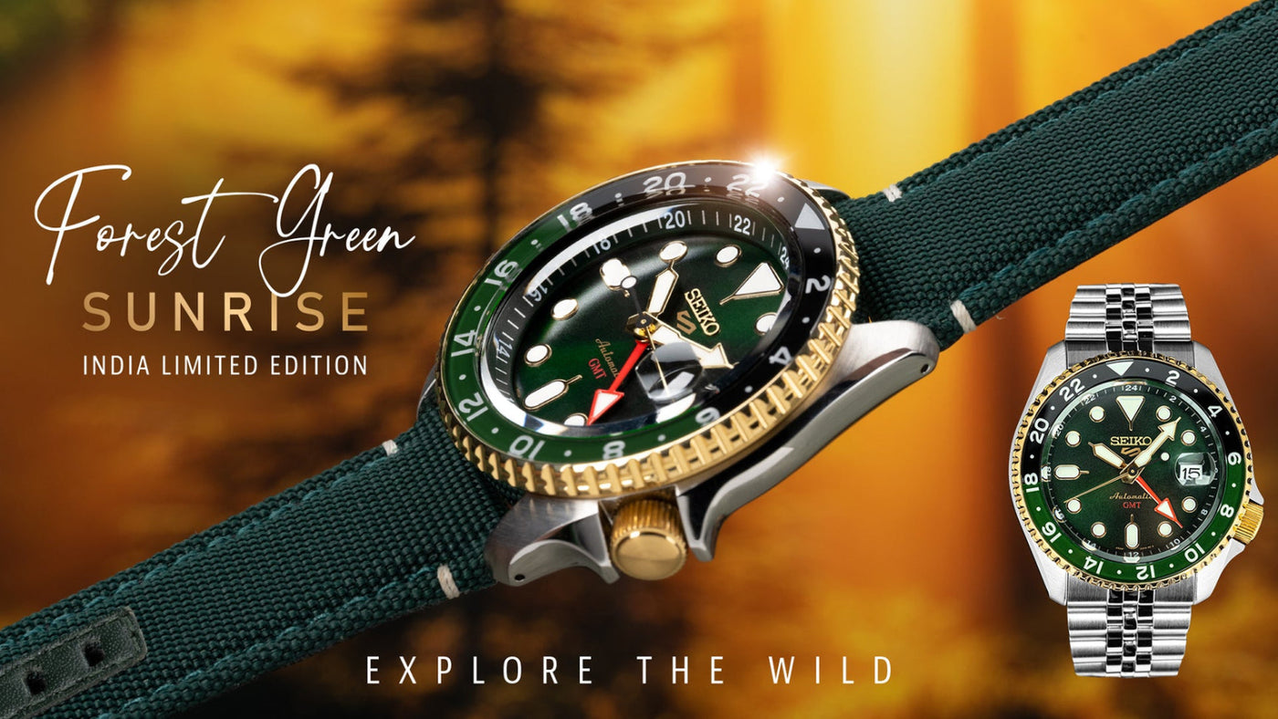 Two watches with green straps and green faces on a blurred natural background.